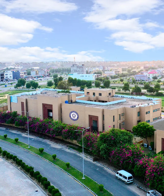 Aerial view of the Lake City campus behind a long wall of pink bougainvillea.